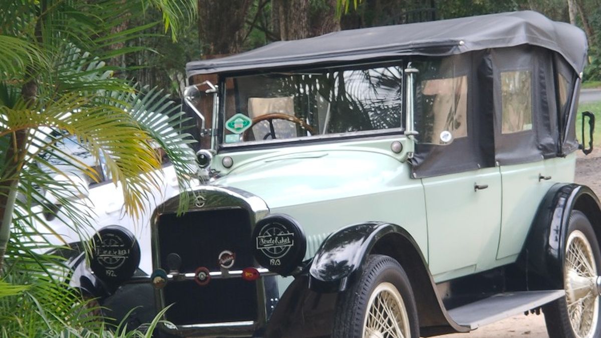 Old car at cafe, passed us on return on Cane Rd