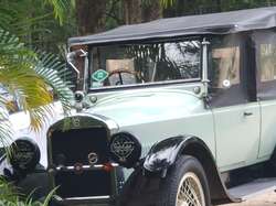 Old car at cafe, passed us on return on Cane Rd